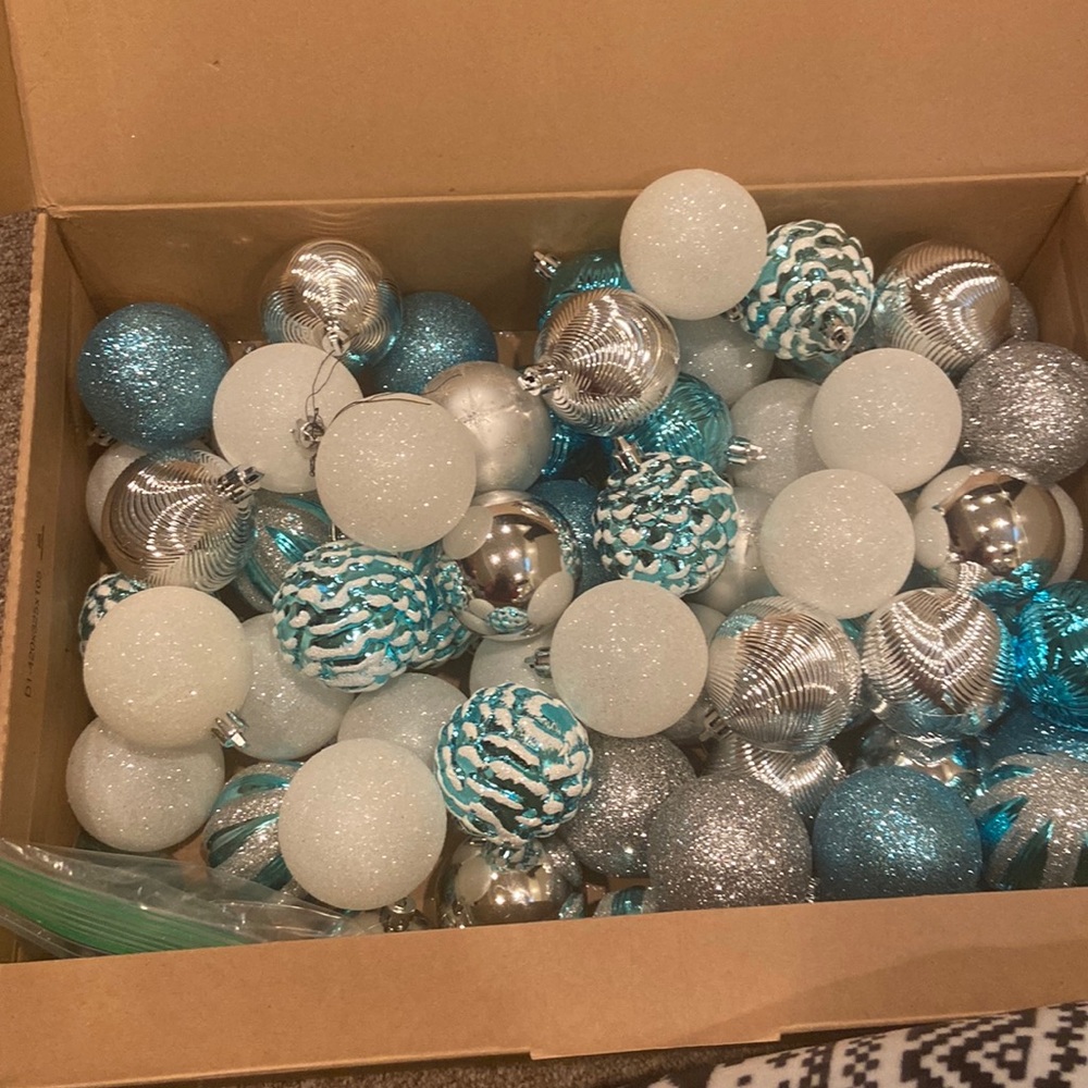 A bunch of blue,white, and sliver ornaments